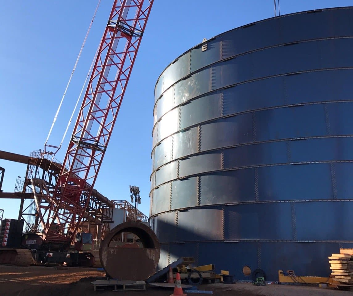 Large bolted storage tank at an industrial project site
